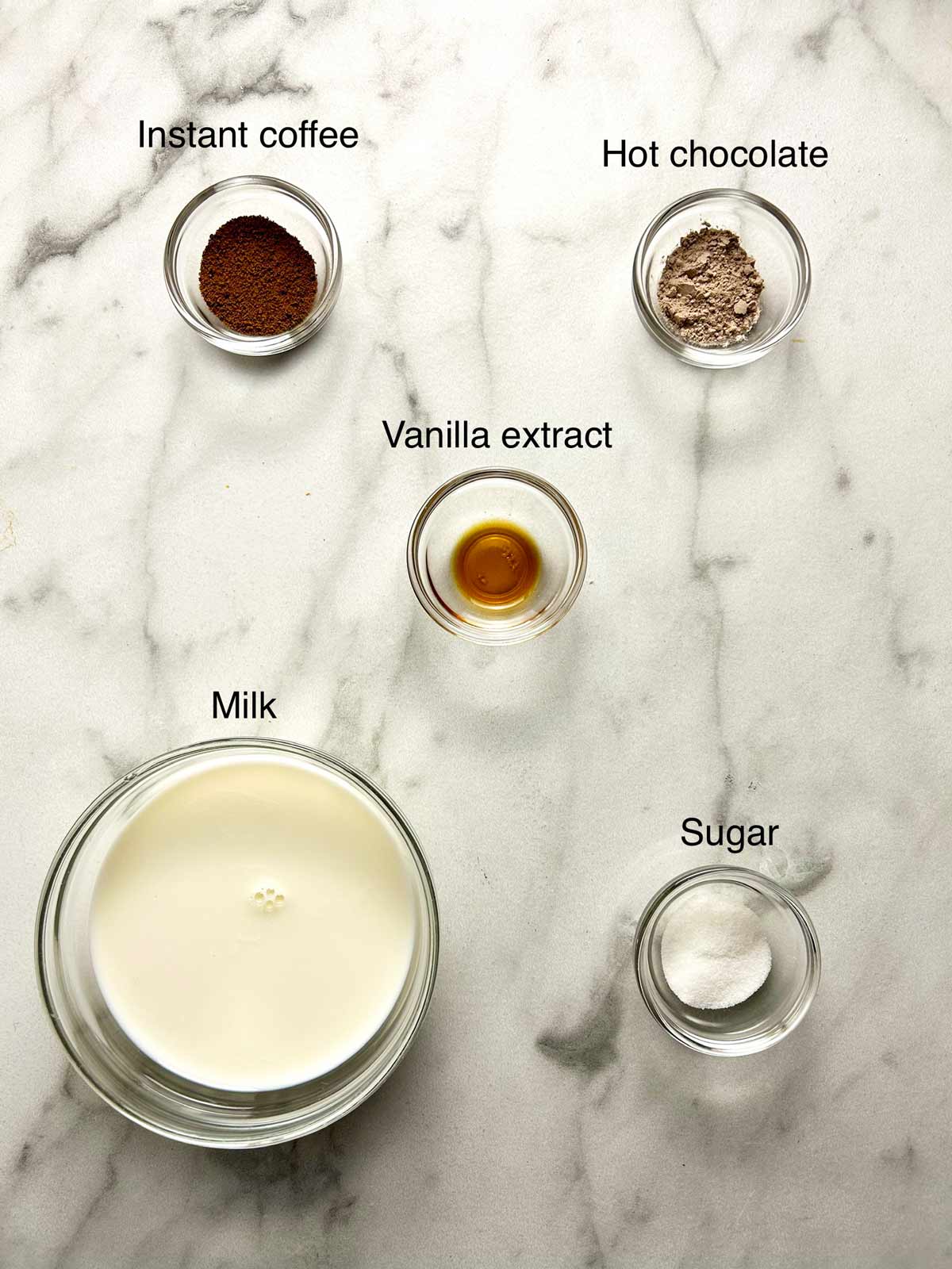 Ingredients for hot chocolate on a marble surface