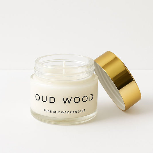 Jar of 'Oud Wood' pure soy wax candles with a gold lid on a white background