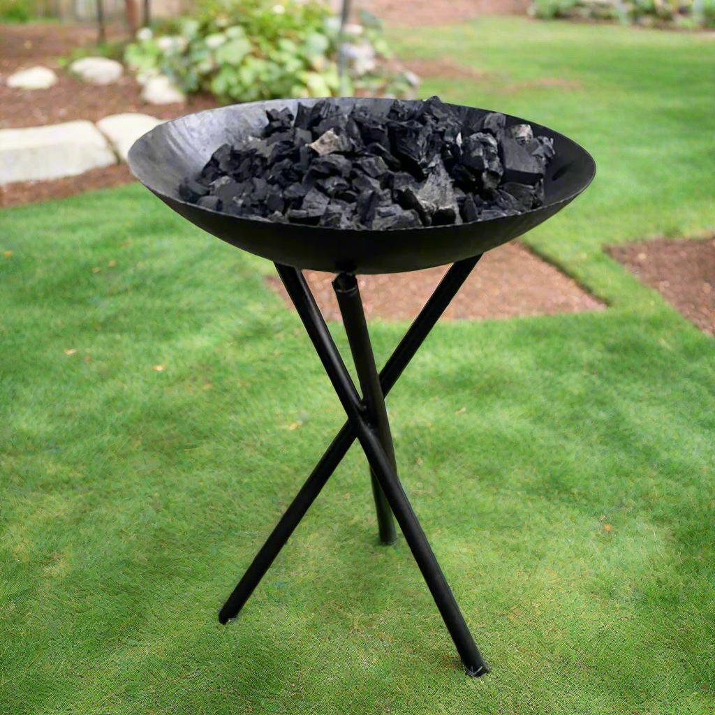 Metal outdoor fireplace. Black bowl on a tripod.