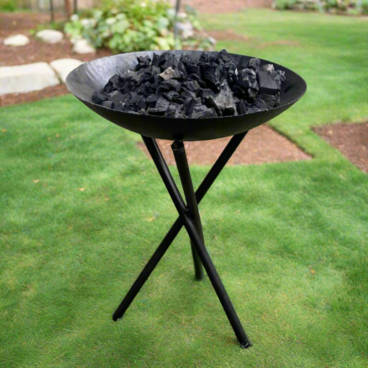 Metal outdoor fireplace. Black bowl on a tripod.